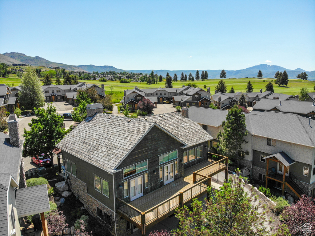 Aerial perspective of suburban area featuring a mountainous background