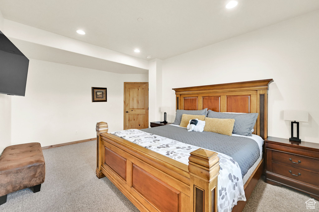 Bedroom with light carpet and recessed lighting