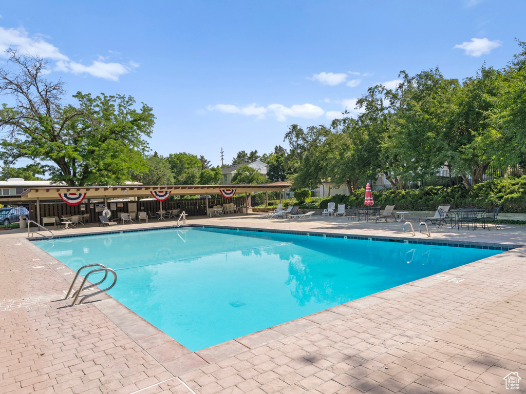 Community pool featuring a patio