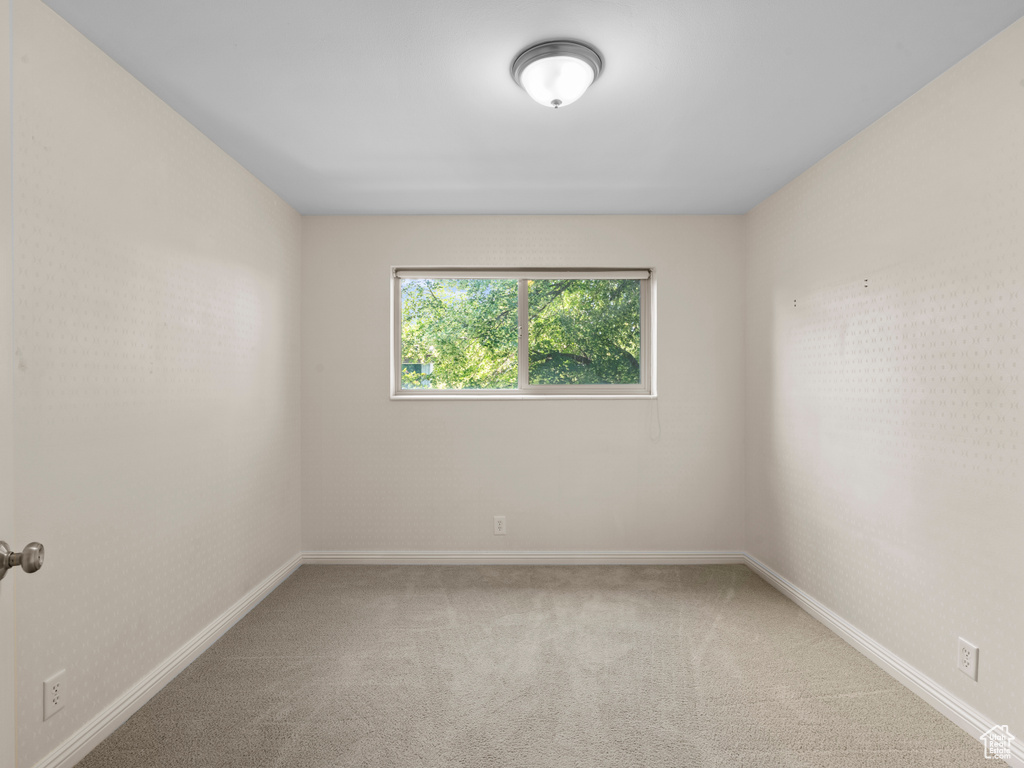 Carpeted empty room with baseboards