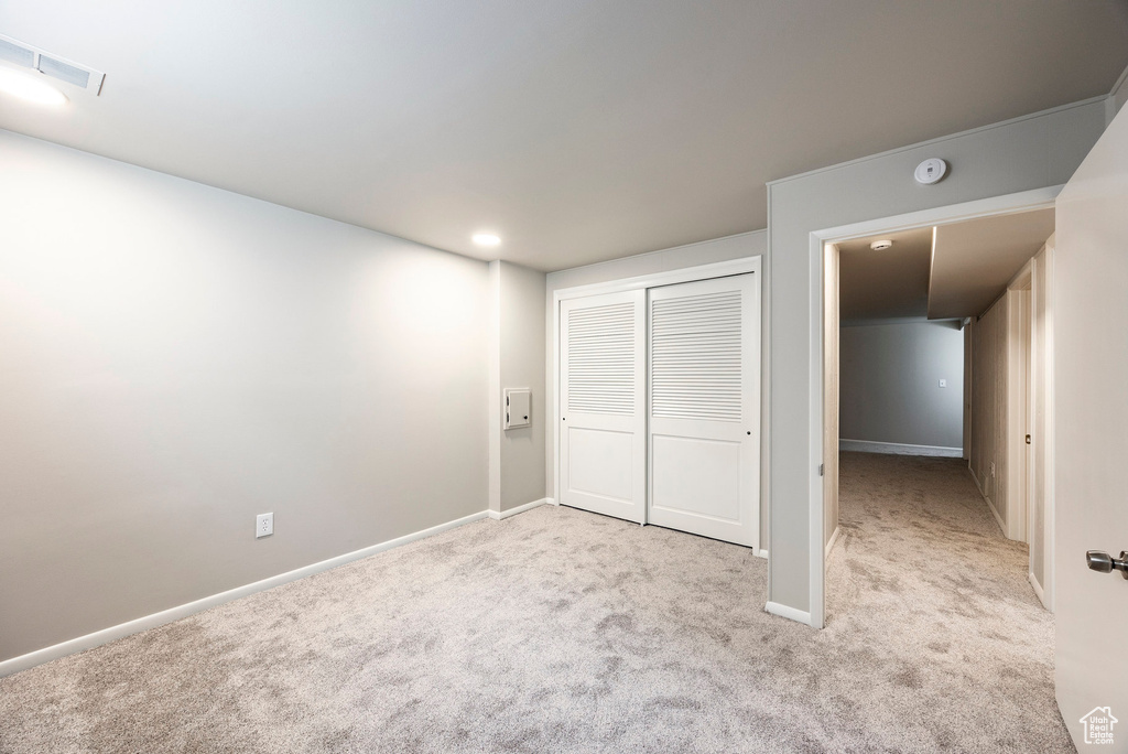 Unfurnished bedroom featuring carpet, a closet, and recessed lighting