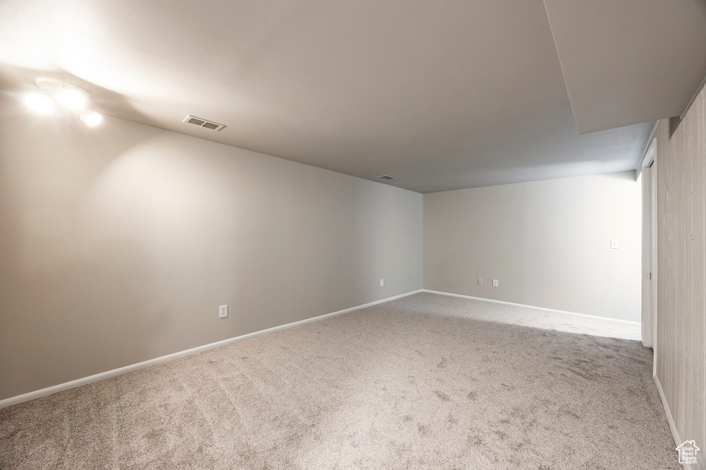 Spare room featuring carpet and baseboards