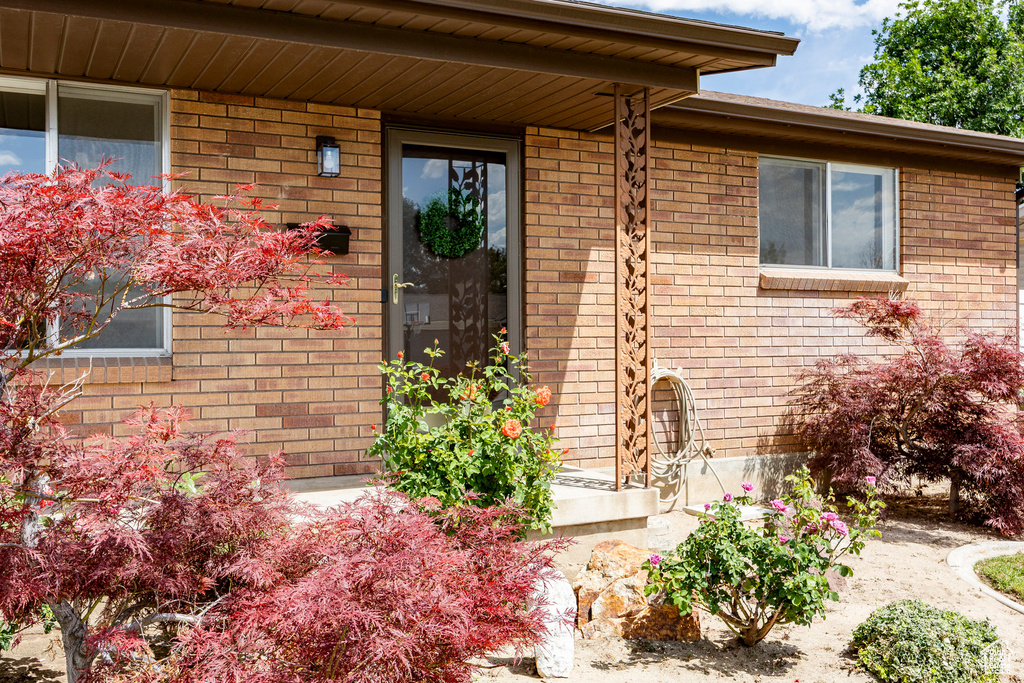 View of exterior entry featuring brick siding
