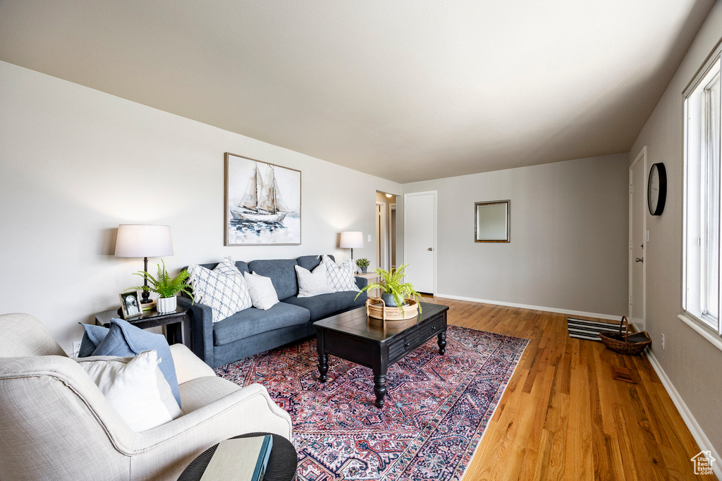 Living room featuring light wood-style floors and baseboards