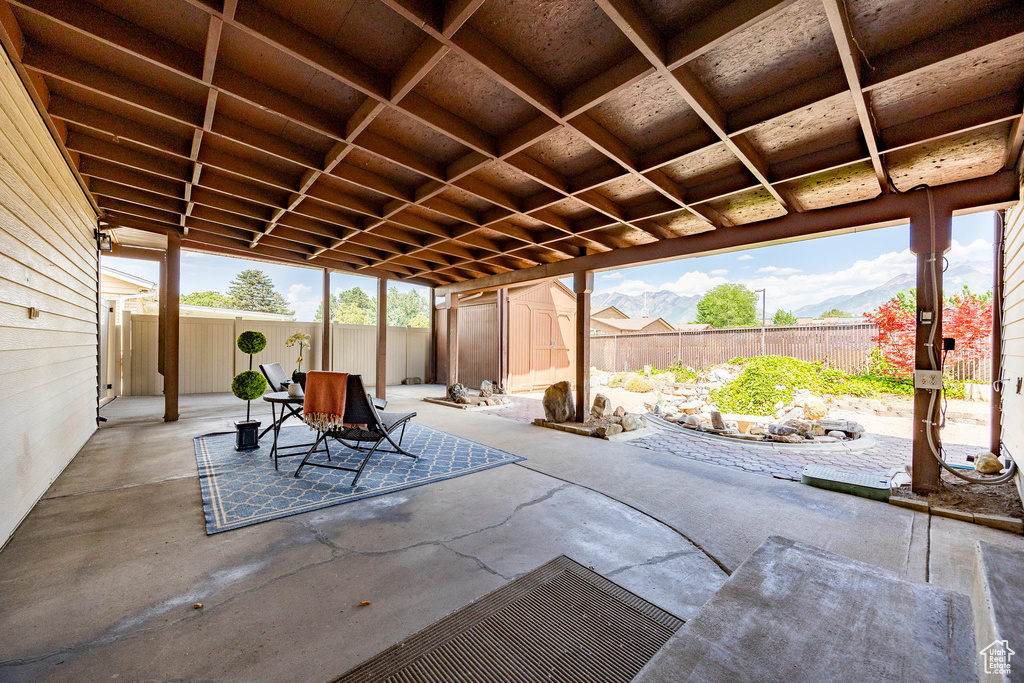 Fenced backyard featuring a shed and a patio area