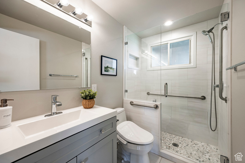 Full bathroom with a shower stall and vanity