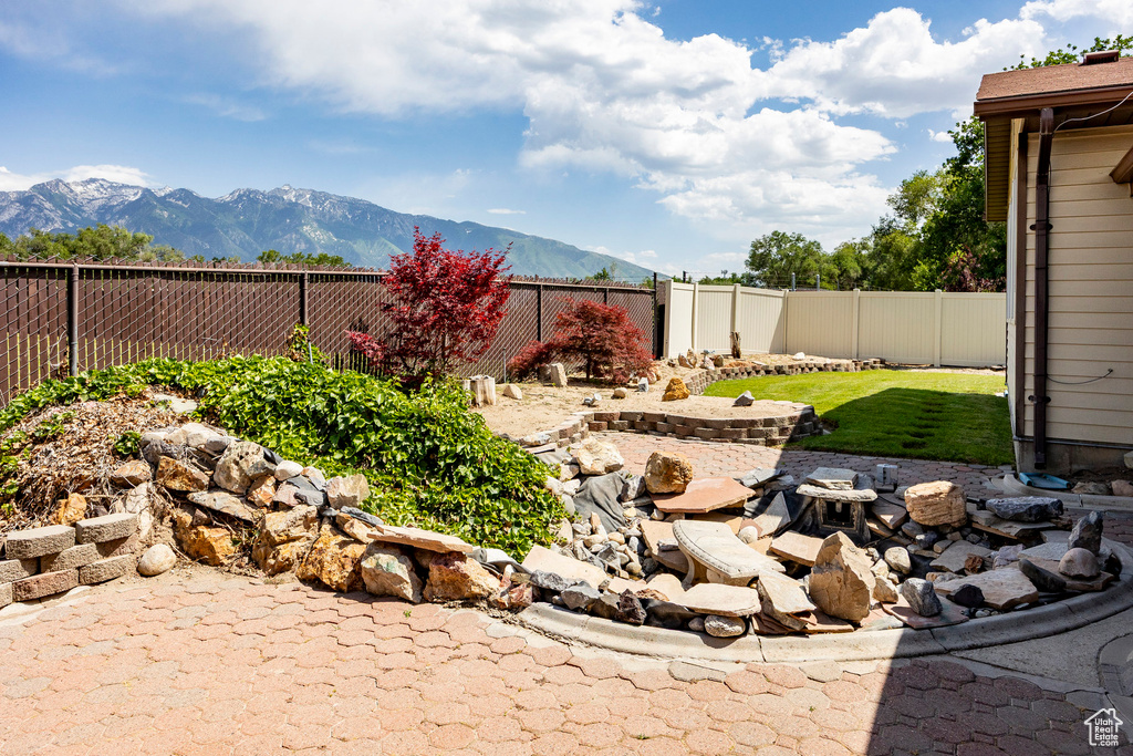 Fenced backyard featuring a mountain view
