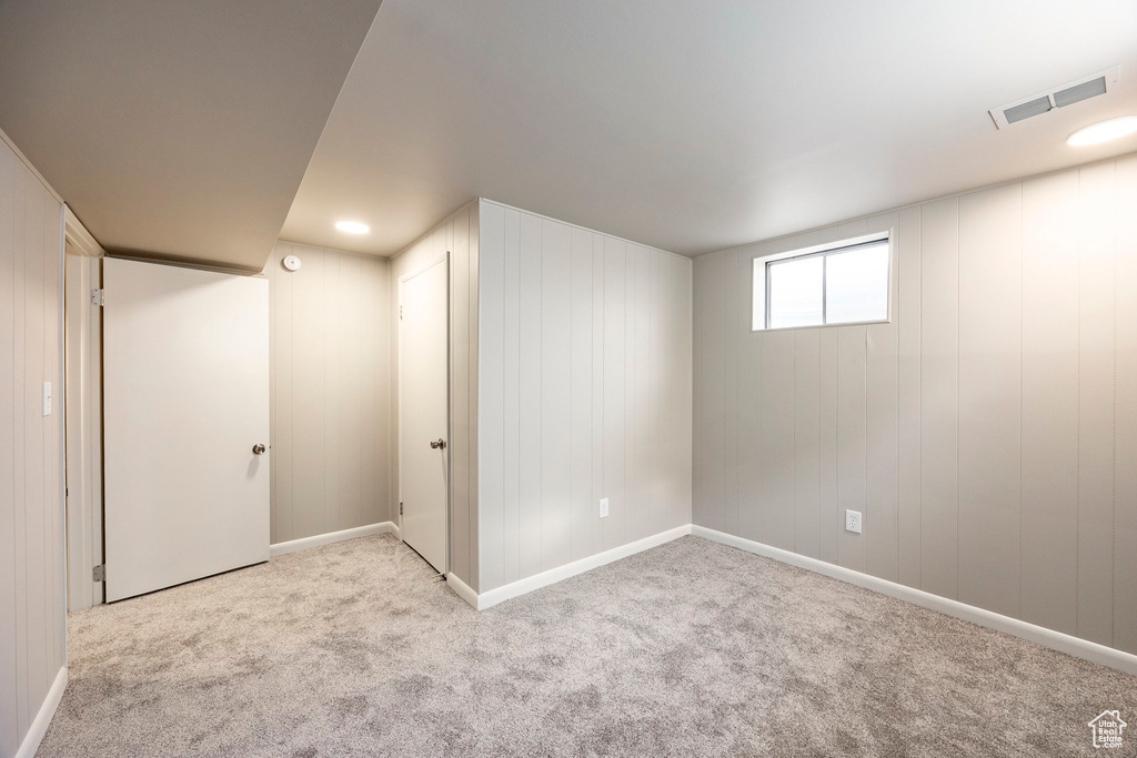 Basement featuring carpet floors and baseboards