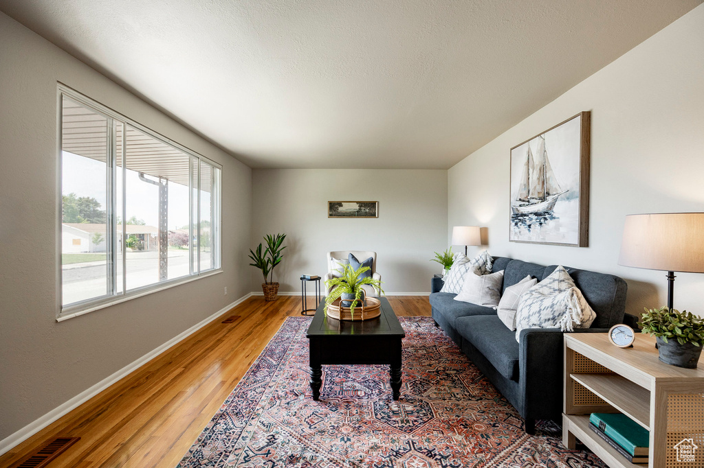 Living room with light wood-style flooring and baseboards