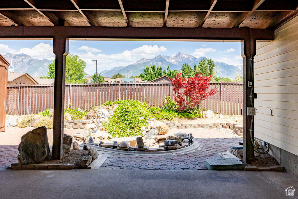 Fenced backyard with a mountain view and a patio
