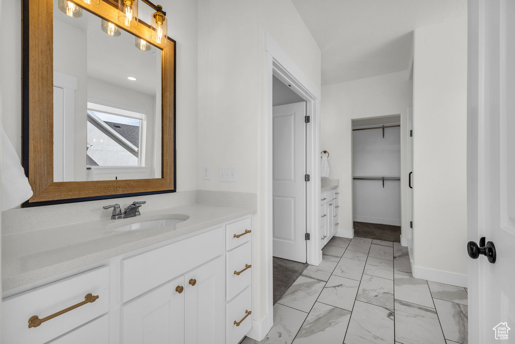 Full bathroom featuring vanity and marble finish flooring