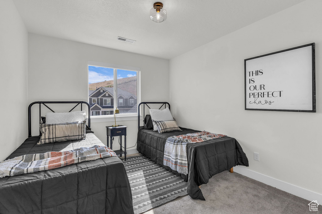 Bedroom featuring carpet floors and baseboards