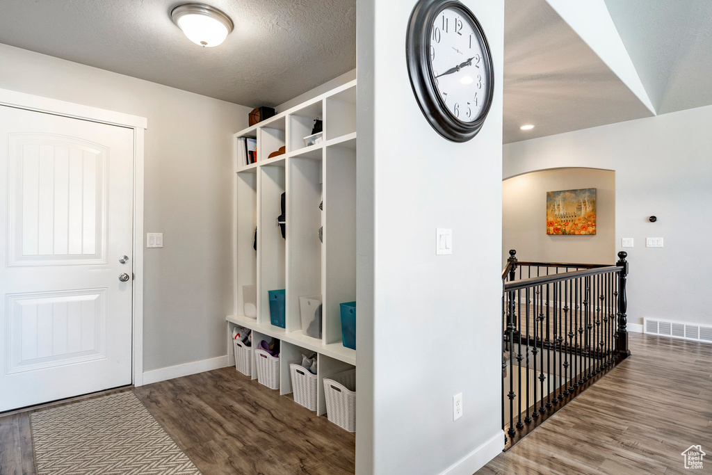 Mudroom with wood finished floors and baseboards
