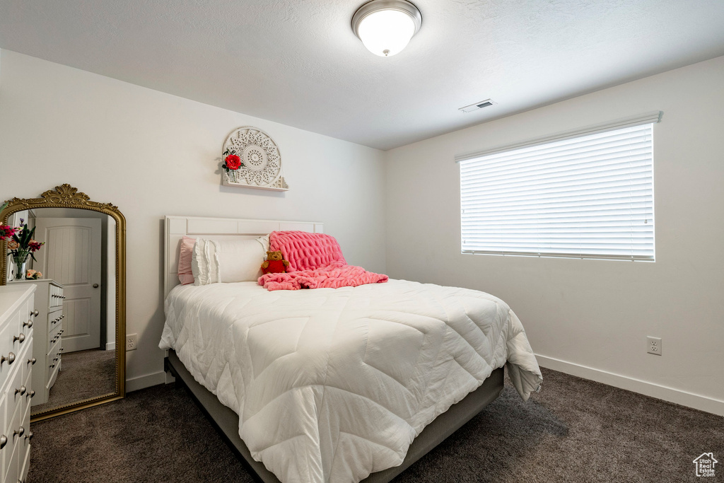 Bedroom with dark carpet