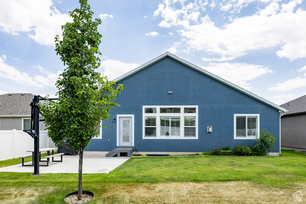 Back of house with a patio and stucco siding
