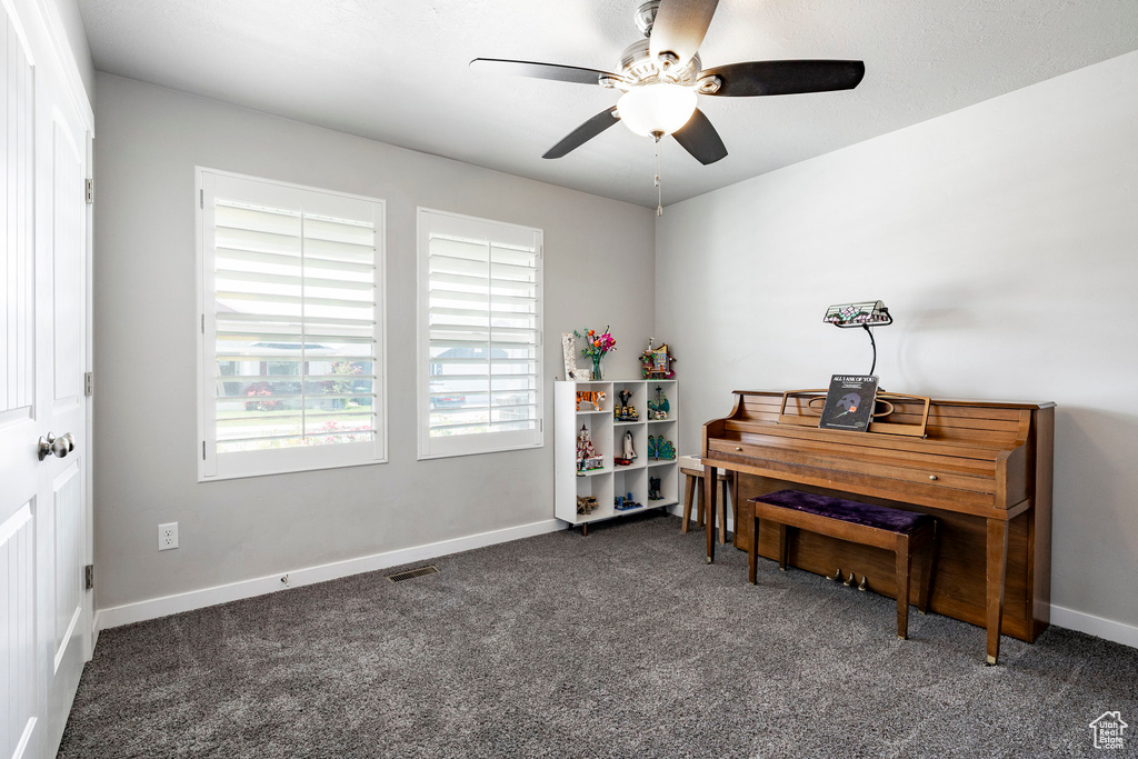 Office space featuring a ceiling fan and carpet floors