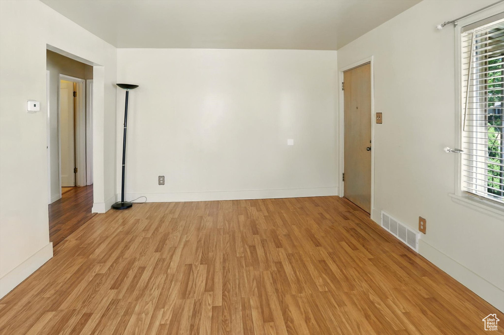 Spare room with light wood-style flooring and plenty of natural light