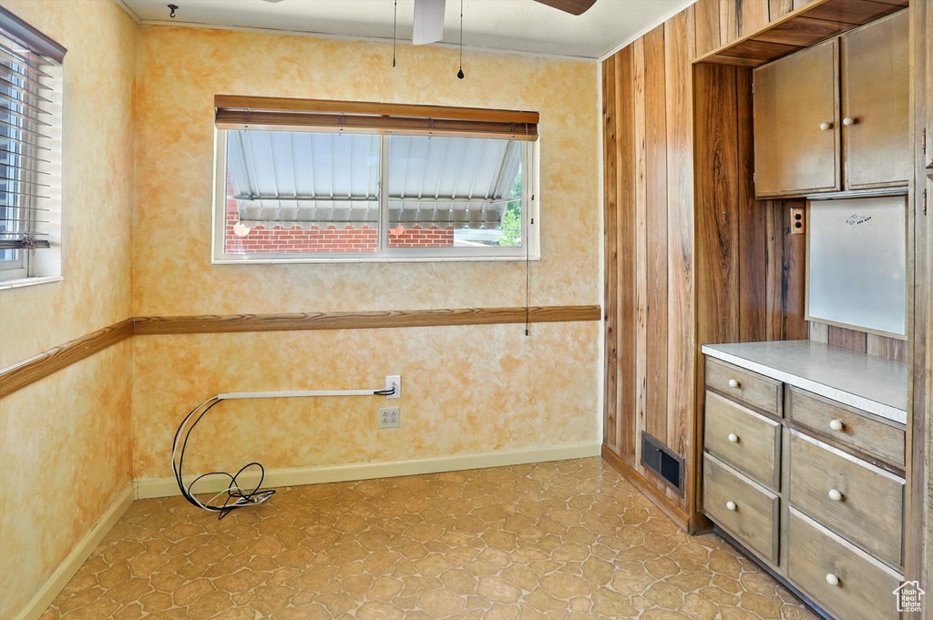 Kitchen featuring ceiling fan and light countertops