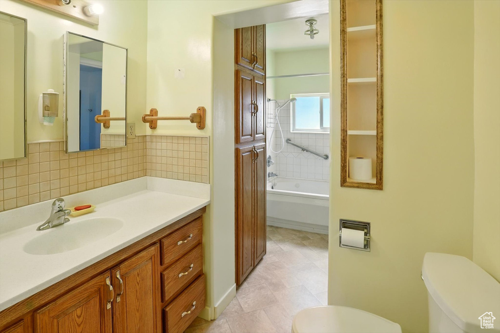 Full bathroom with vanity, tile patterned floors, bathing tub / shower combination, and decorative backsplash
