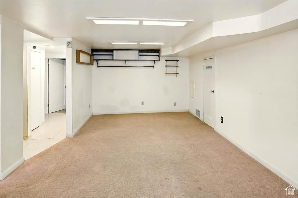 Finished below grade area featuring light colored carpet