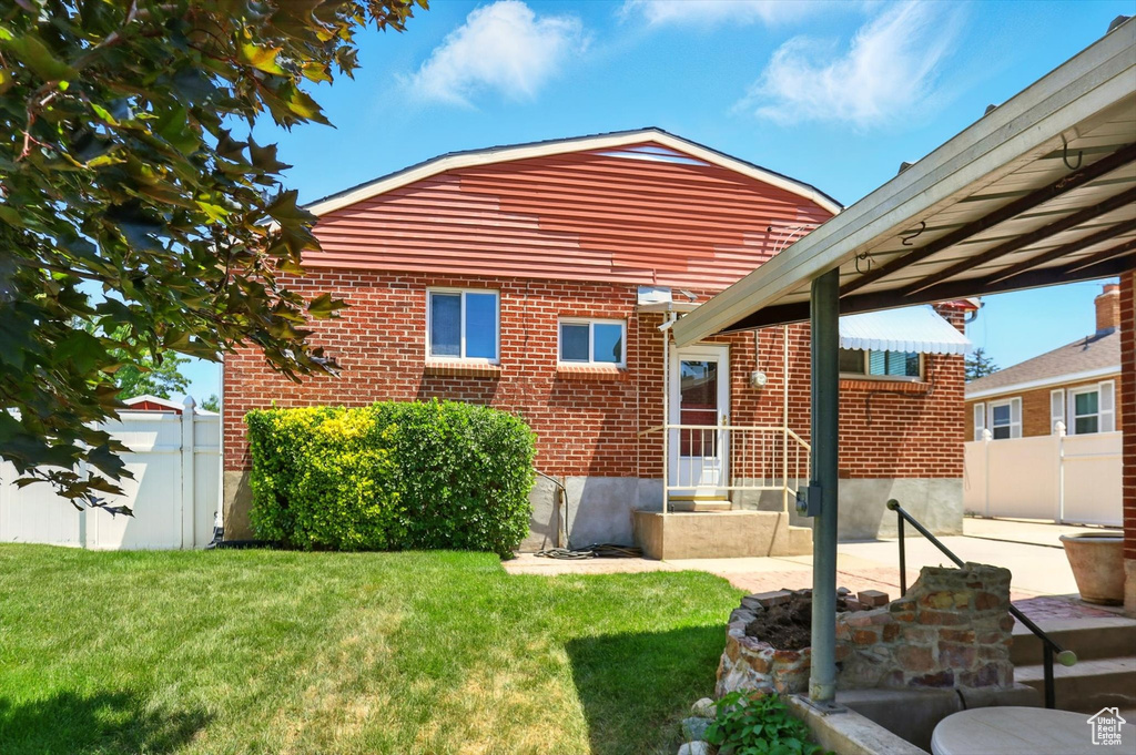 Rear view of house with brick siding