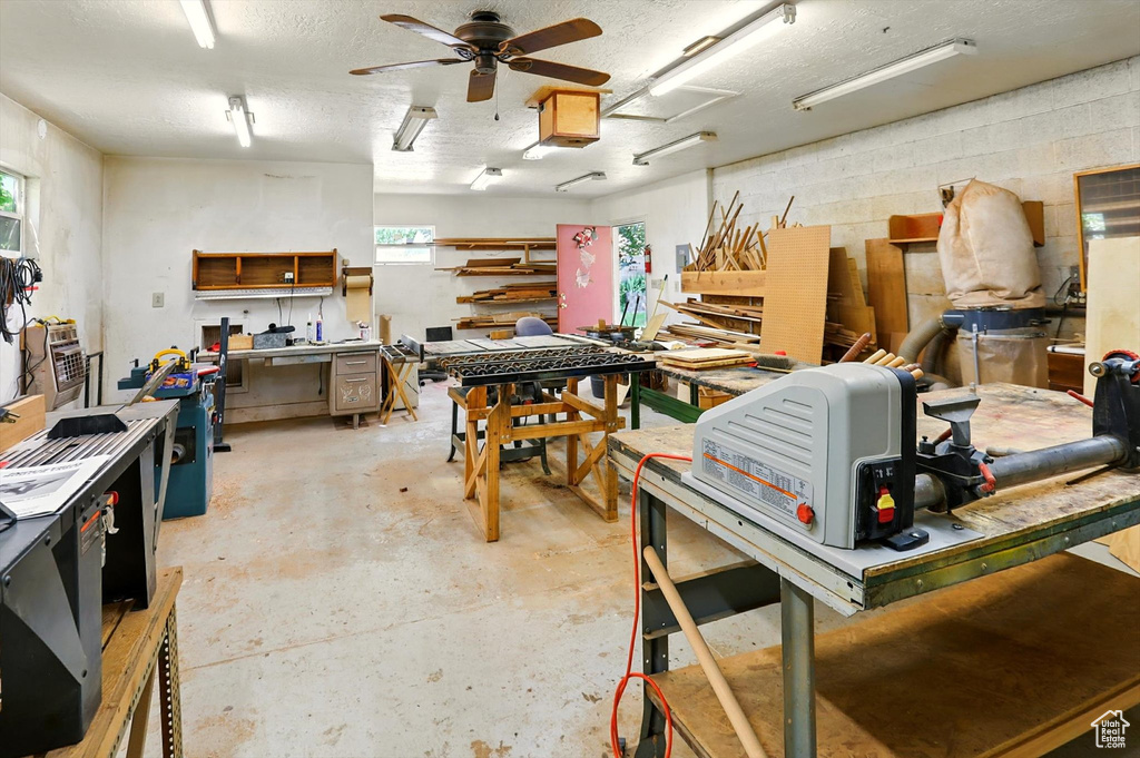 Garage featuring a workshop area and a ceiling fan