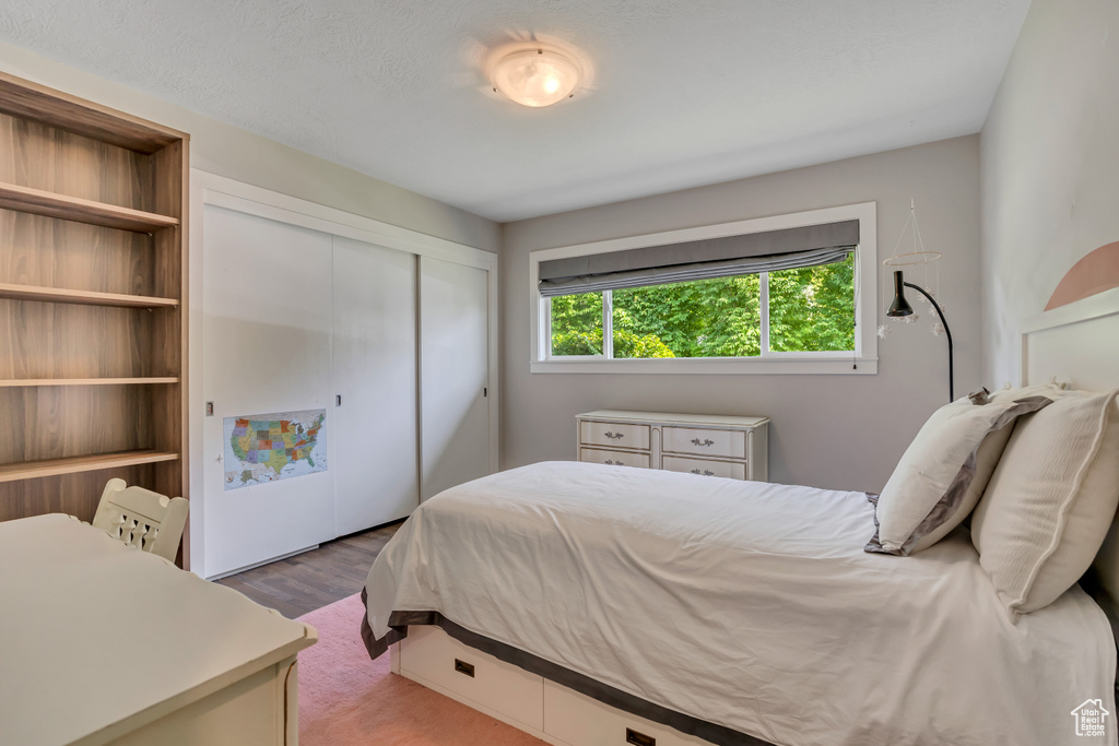 Bedroom featuring a closet and wood finished floors