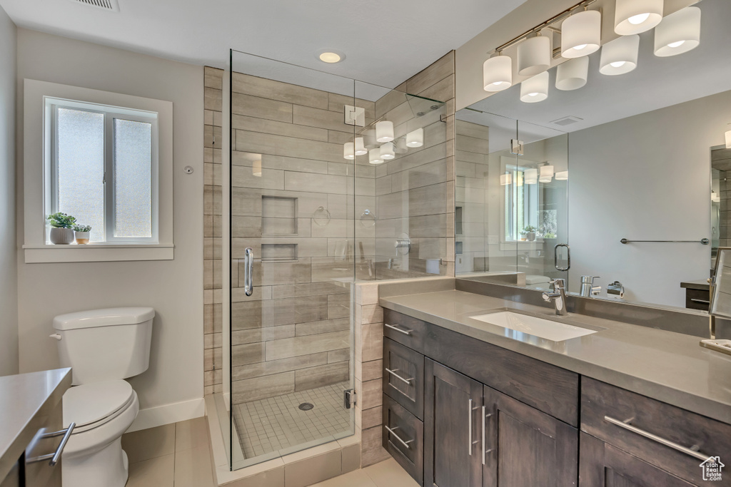 Full bathroom featuring vanity, tile patterned flooring, a stall shower, and recessed lighting