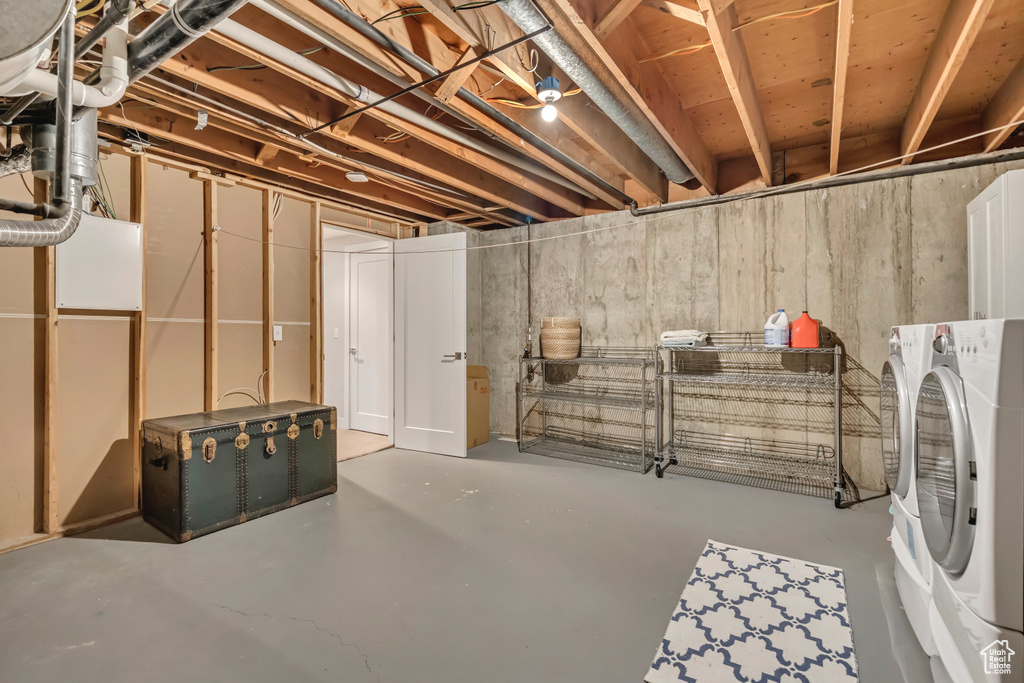 Unfinished below grade area with washing machine and dryer