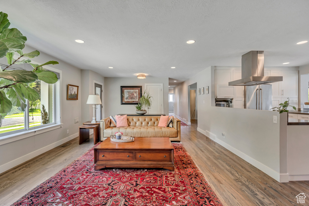 Living room featuring light wood finished floors and recessed lighting