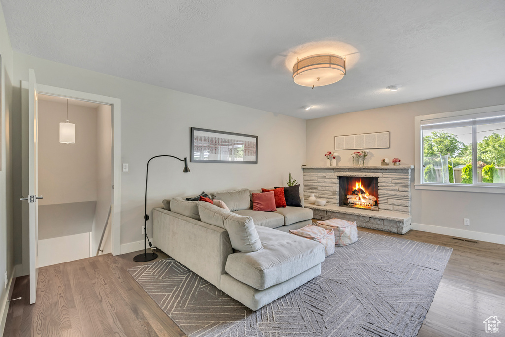 Living room with wood finished floors and a fireplace