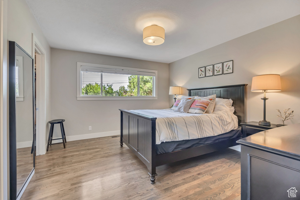 Bedroom with light wood-style floors and baseboards