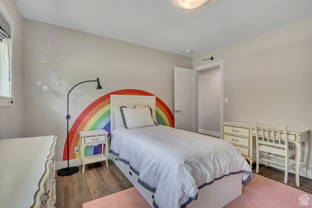 Bedroom featuring dark wood-style floors and baseboards