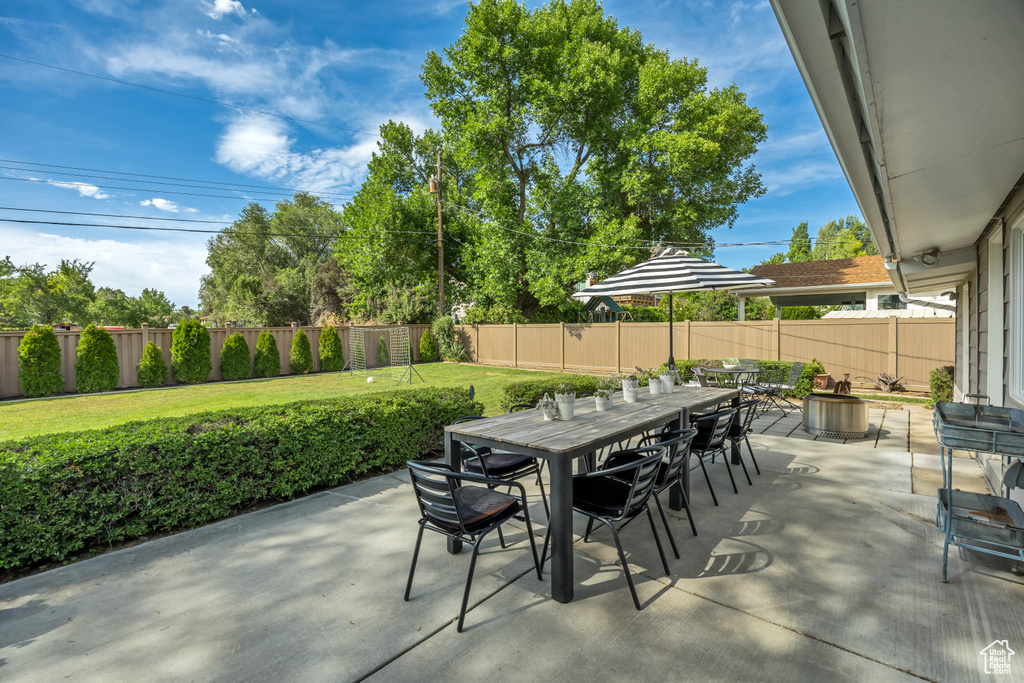 Fenced backyard featuring outdoor dining area and a patio