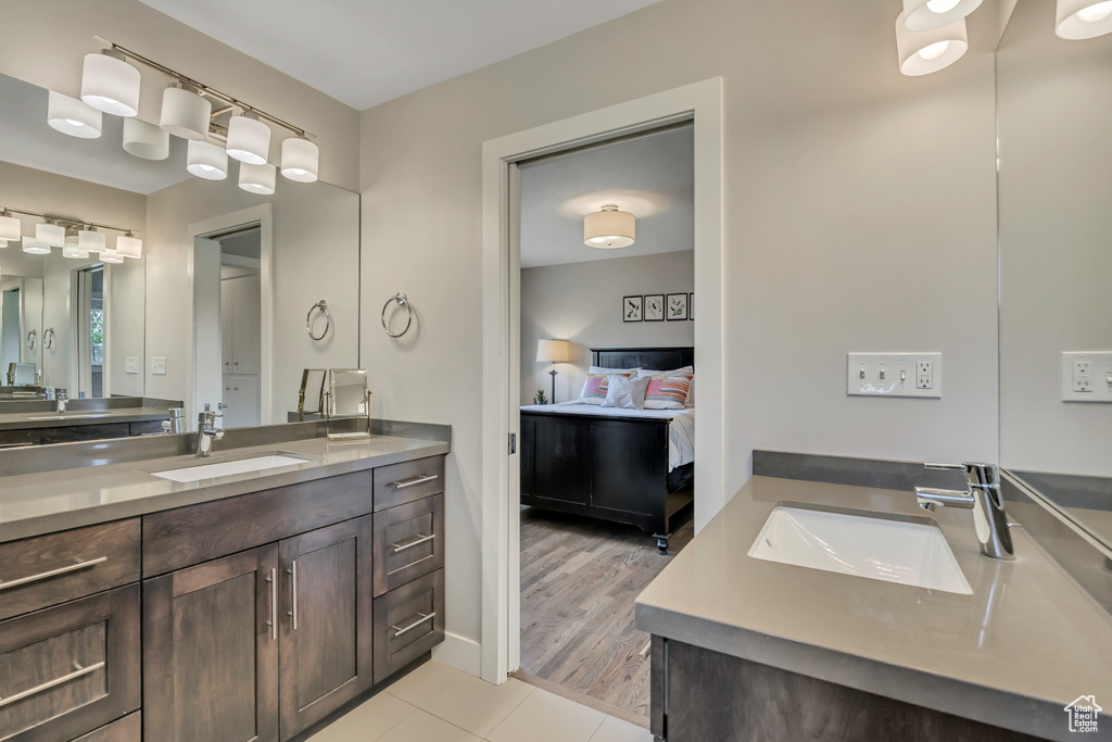 Ensuite bathroom with two vanities and tile patterned floors