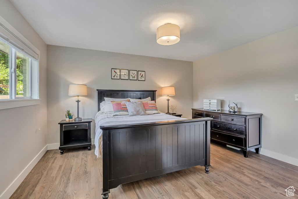 Bedroom with light wood-type flooring and baseboards
