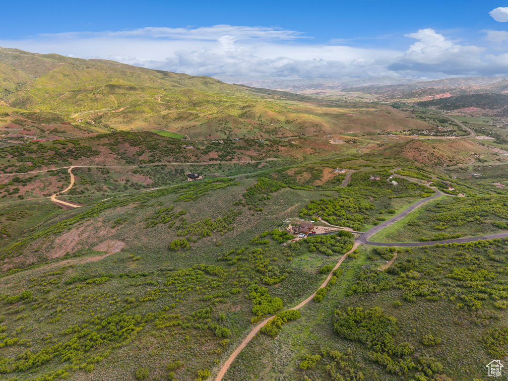 Aerial view of property and surrounding area with mountains