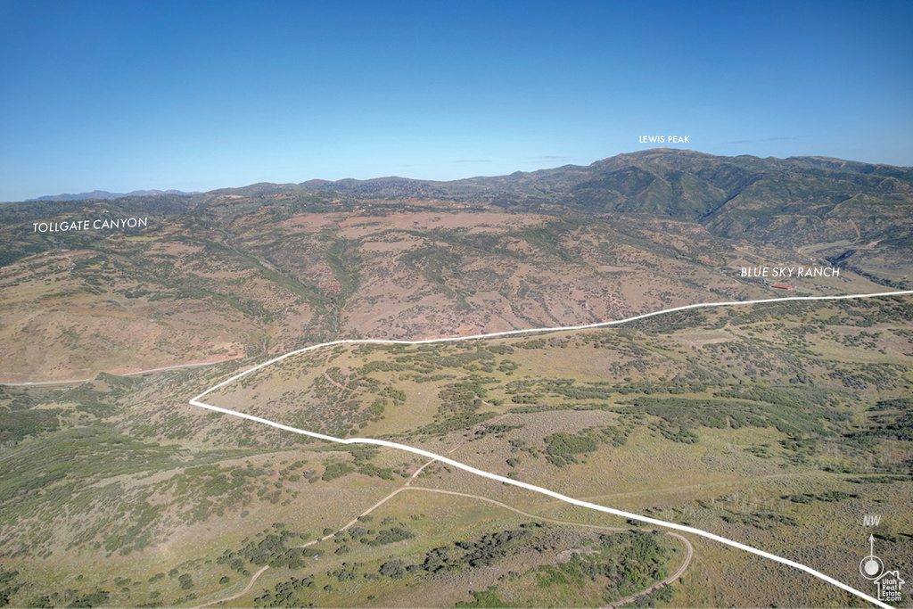 Aerial view of property and surrounding area with property parcel outlined and mountains