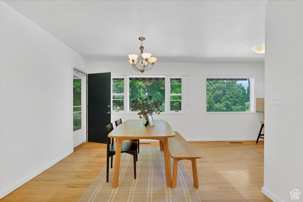 Dining space featuring light wood-style flooring and a chandelier