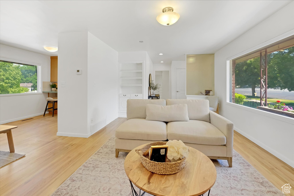 Living area with light wood-style floors and baseboards