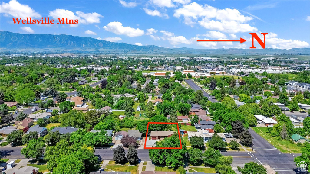 Aerial view of residential area with mountains and property parcel outlined