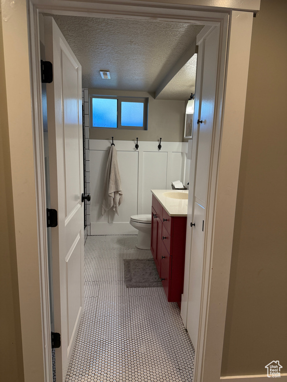 Bathroom featuring vanity and a textured ceiling