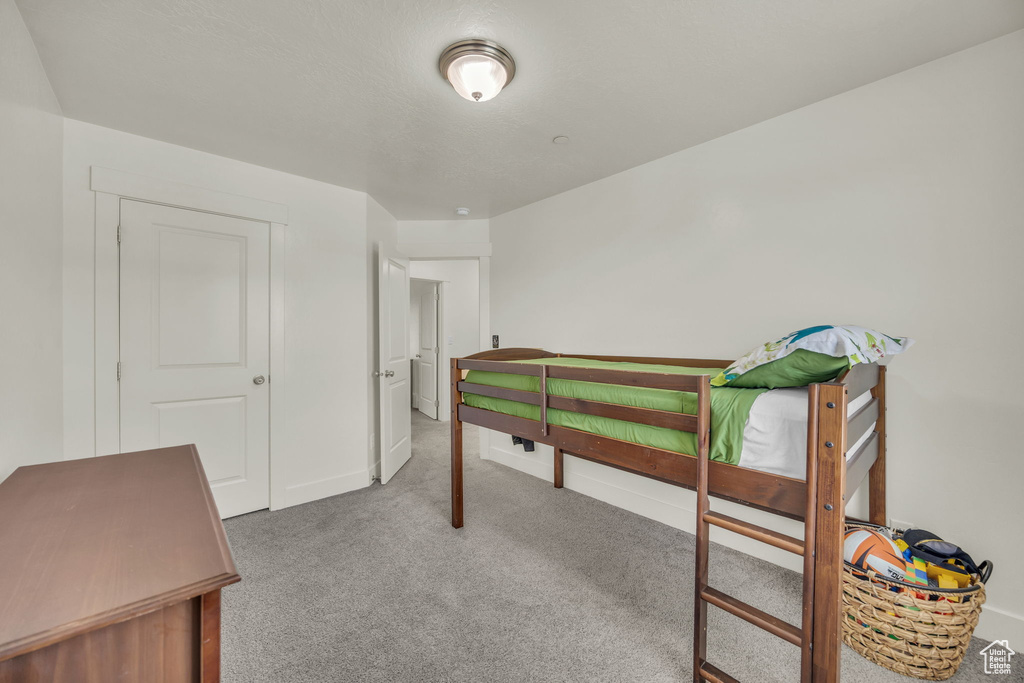 Carpeted bedroom with baseboards