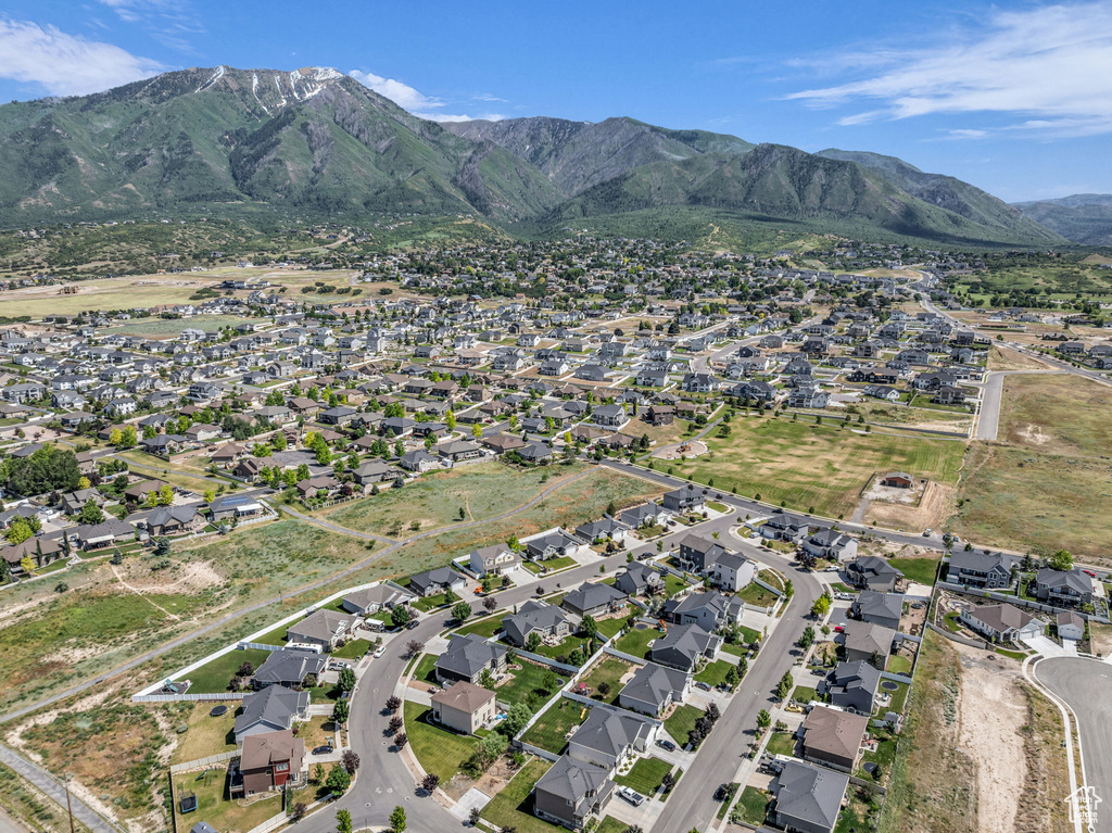 Aerial view of property's location with a mountain backdrop and nearby suburban area