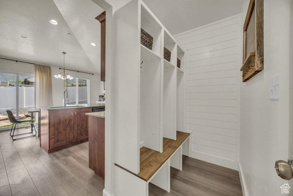 Mudroom featuring light wood-style floors, a chandelier, recessed lighting, and a textured ceiling