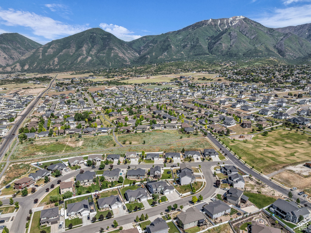 Aerial overview of property's location featuring nearby suburban area and a mountainous background