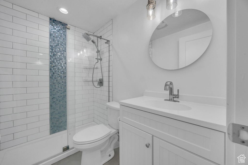 Bathroom featuring a shower stall, vanity, and recessed lighting