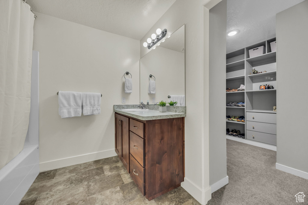 Full bath with vanity and shower / bath combination with curtain