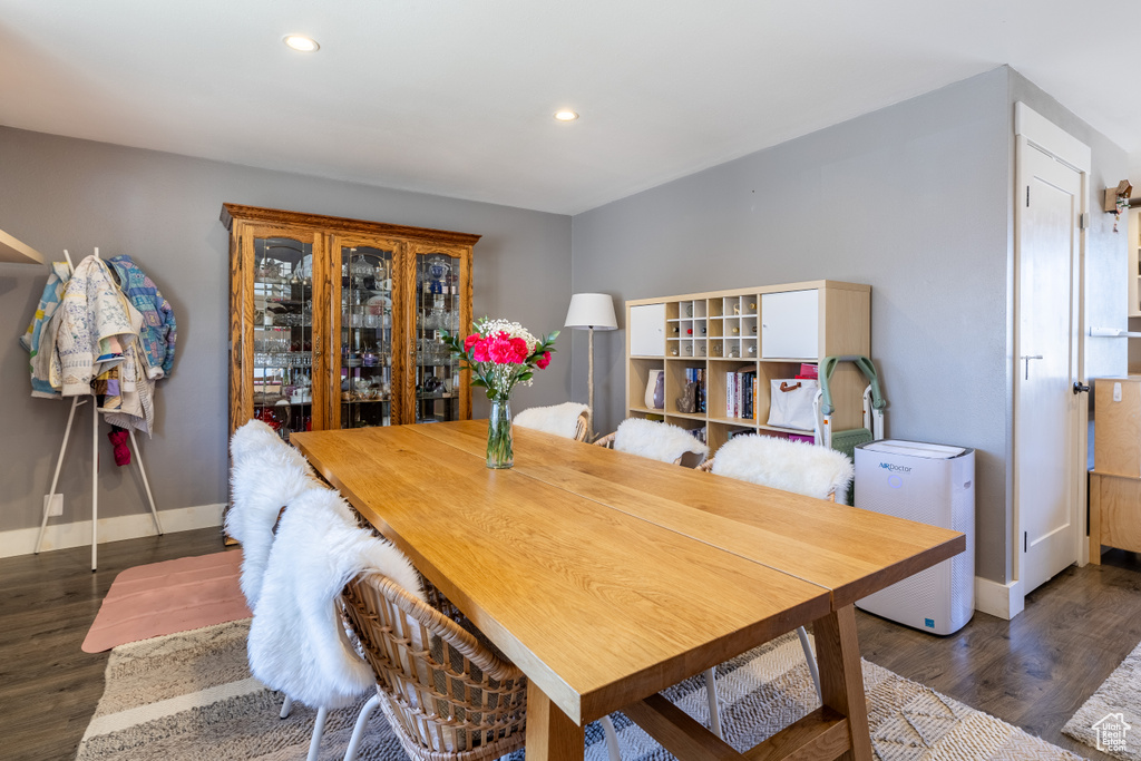 Dining space with wood finished floors and recessed lighting