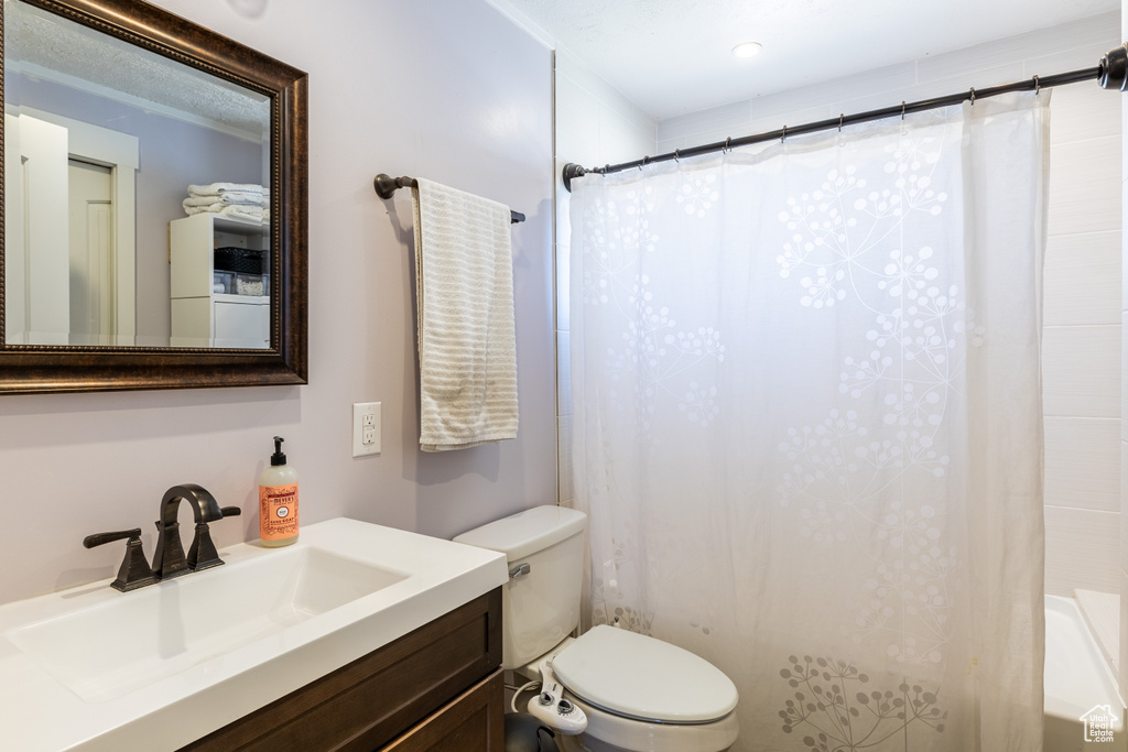 Full bath with vanity and shower / bath combination with curtain